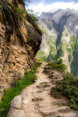 Mountain road in one of the deepest ravines of the world, Tiger Leaping Gorge in Yunnan, Southern...