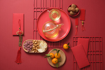 Lunar New Year concept background. A traditional New year table with food, nut tea, and ornaments...