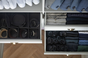 Man cupboard clothes storage organization neatly folded belt underwear shirt and socks