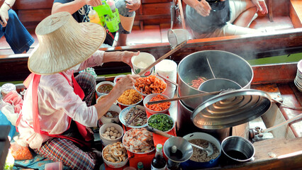 Sellers selling Thai noodle on boats, Ancient travel destination of Thailand Damnoen saduak flating market, Ratchaburi Thailand.
