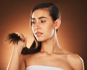 Hair, keratin and treatment with a model woman in studio on a brown background for damage or split ends. Salon, haircare and shampoo with a frustrated female suffering or annoyed with her hairstyle - obrazy, fototapety, plakaty