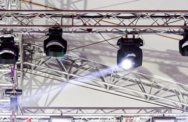 professional lighting equipment on outdoor concert stage. stage spotlight with light beams.