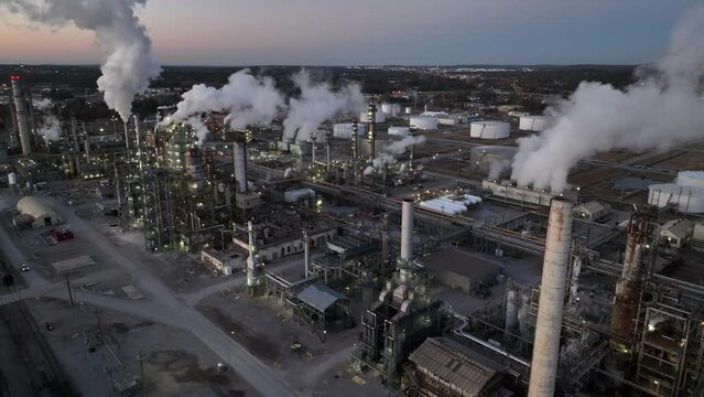Oil and gas petroleum refinery in USA. Aerial at daybreak. Air quality and environmental impact theme.