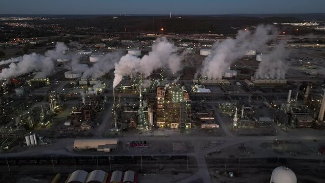 Oil and gas refinery in Tulsa Oklahoma USA. Aerial at night. Carbon footprint fossil fuel theme.
