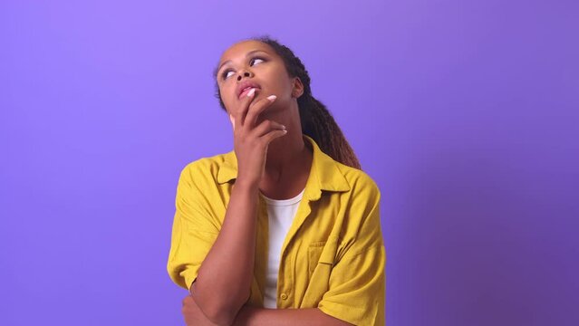 Young upset attractive African American woman in casual clothes embarrassedly makes facepalm gesture shocked by unpleasant news or unexpected problems stands on plain lilac background