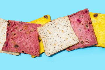 Whole grain bread slices on blue background.