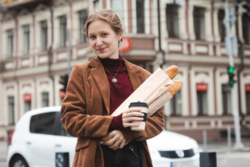 beautiful girl with baguettes and coffee