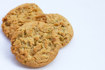 Pistachio and almond cookies on white background.