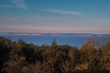 2022-11-28 VIEW OF WHIDBEY ISLAND FROM CAMANO ISLAND WITH A NICE SKY AND EVERGREEN TREES IN THE FOREGROUND