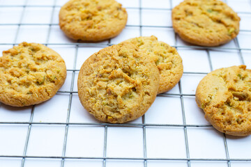 pistachio and almond cookies on white background.