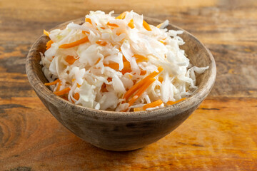 Sauerkraut in wooden bowl. Food background.