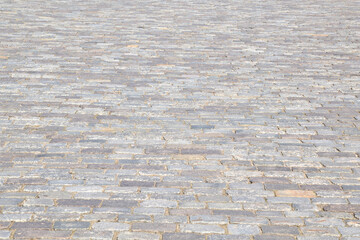 Background from the road paved with stone