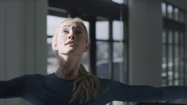 Tilt up to slow motion close up of woman practicing spinning in dance studio / Lehi, Utah, United States