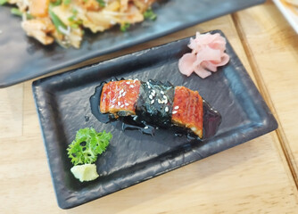 Unagi Sushi (Eel Hand Roll) is a popular sushi roll featuring Japanese eel cooked in a rich umami sauce, then rolled in seasoned sushi rice