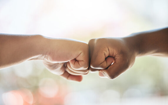 Fist bump, race solidarity and hands of team together for team building support, diversity and partnership collaboration. Bokeh background, racism and friendship greeting for teamwork welcome