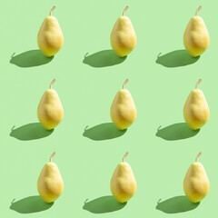 Seamless pattern with fresh pear on green background.