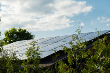 New ecologic house with solar panels Alternative to conventional energy. The battery is charged...