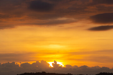 Morning view at morning sunrise, clouds in orange crimson colors. Silhouettes of houses roofs, trees, and a monastery on the hill. Colorful scenery skyline background.