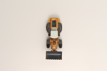 Fototapeta premium a close up of miniature orange wheel loader toy