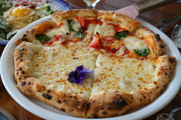 Several types of pizza served on one plate