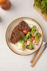 Portion of gourmet beef steak with vegetable salad