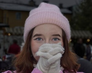 Portrait of a beautiful girl from Sweden, with a background and a pink cap on her head