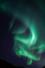 Naklejka na ściany i meble Aurora borealis in the starry night sky over the lake