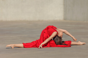 young flexible asian woman in red dress