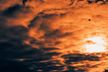 Heavenly landscape of a juicy orange twilight sky with a dove hazy misty haze. Dense clouds. Selective focus.