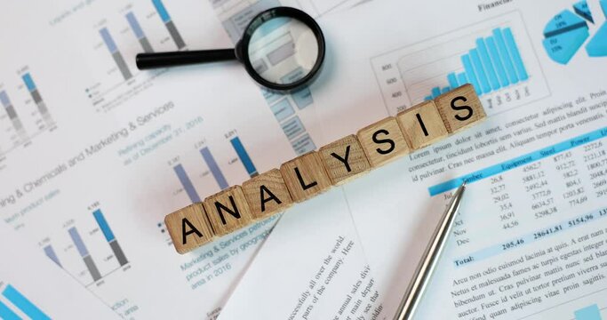 Magnifying glass on financial development graphic with paper