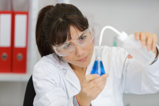 female tech works in chemical lab