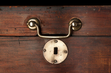 antique wooden chest showing detail of brass handle and lock