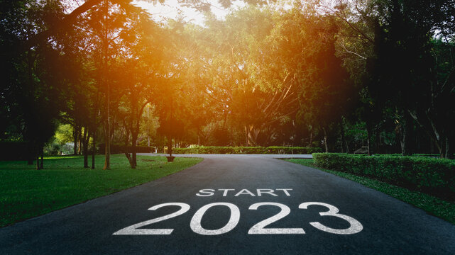 Happy new year 2023,2023 symbolizes the start of the new year. The letter start new year 2023 on the road in the nature garden park have tree environment ecology or greenery wallpaper concept.