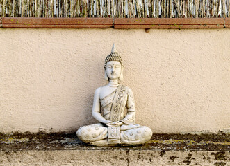 A Buddha figure on the outside of a terrace, gives tranquility to the place