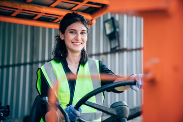 Portrait of woman forklift driver in factory, Woman cargo worker work in warehouse. © kelvn