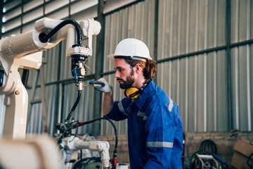 Fototapeta na wymiar Industrial engineer wearing a white helmet working in industrial factory. 