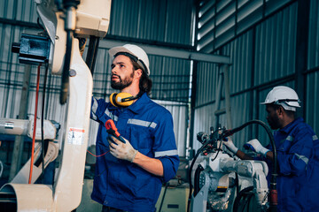 Team of technician worker checking and repair pressing metal machine at factory, Machine maintenance technician operation concept.