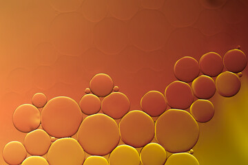 Oil and water bubbles background on brown orange colour.