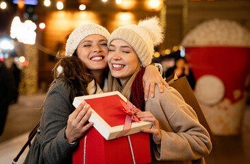 Fototapeta na wymiar Portrait of happy women exchanging christmas presents. Holiday people christmas happiness concept