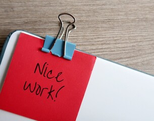 Red note on document with handwriting praise NICE WORK!, concept of giving positive feedback in...