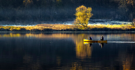Canoeing in a calm lake in the winter morning