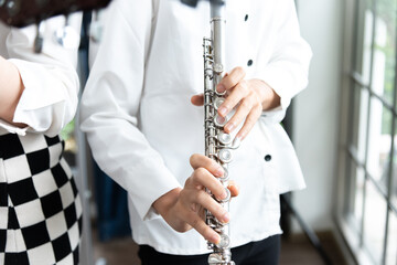 Flute :  A closeup of hands of a musician playing the flute, detail shot, classical music, wind...