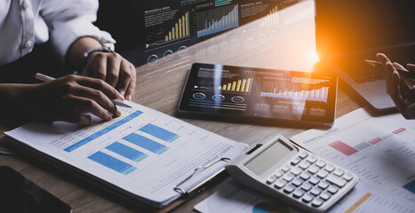 Technology and financial advisory services concert. Business teamwork and working on digital laptop computer with advisor showing plan of investment to clients at table office. Digital marketing.