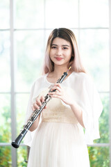 Portrait of Young Female Musician Playing Clarinet. Rehearsal before performing on stage.