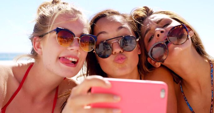 Beach, sunglasses and girl friends take selfie on phone, fun and sun on summer vacation in Bali. Travel, friendship and ocean, happy women taking profile picture on smartphone on holiday in Indonesia