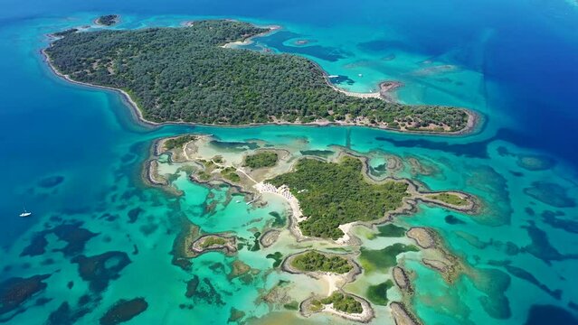 Aerial drone video of exotic paradise volcanic island complex forming a blue lagoon archipelago and featuring sandy beaches in tropical destination