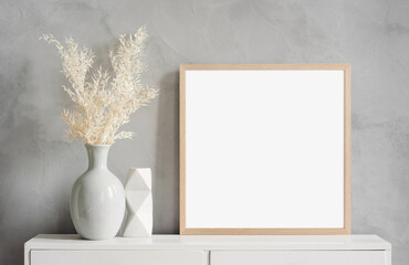 Blank picture frame mockup on gray wall. White living room design. View of modern scandinavian style interior with artwork mock up on wall. Home staging and minimalism concept © kite_rin