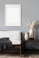 Blank picture frame mockup on gray wall. Modern living room design. View of scandinavian rustic style interior with chair. Home staging and minimalism concept