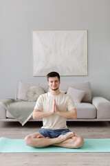 A young man practices yoga in the studio. yoga class. High quality photo