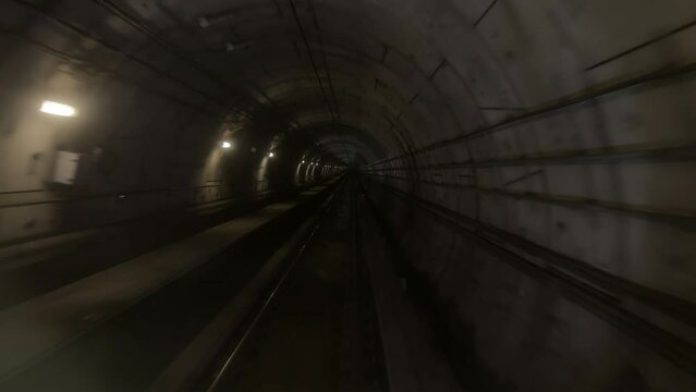Underground dark subway metro rail train mrt running moving through the tunnel from one station to another station